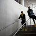 Michigan junior Tim Hardaway Jr. slides down a railing as freshman Spike Albrecht watches on Tuesday, April 9. AnnArbor.com I Daniel Brenner